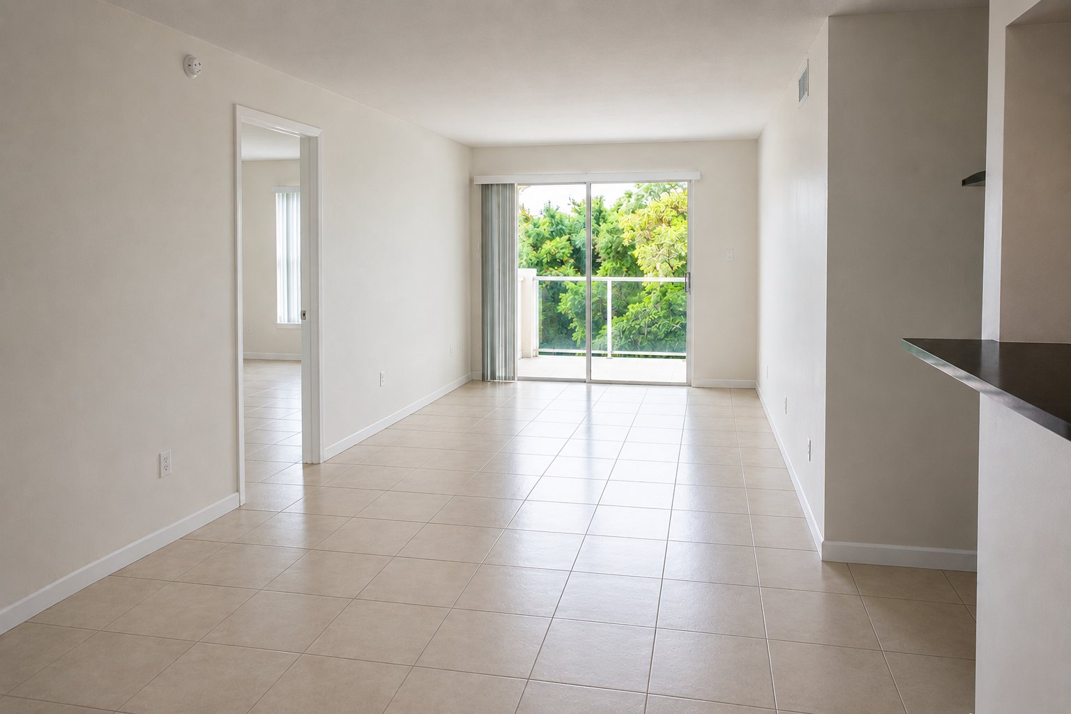 Empty apartment after move-out cleaning with clean floors and bright sliding door